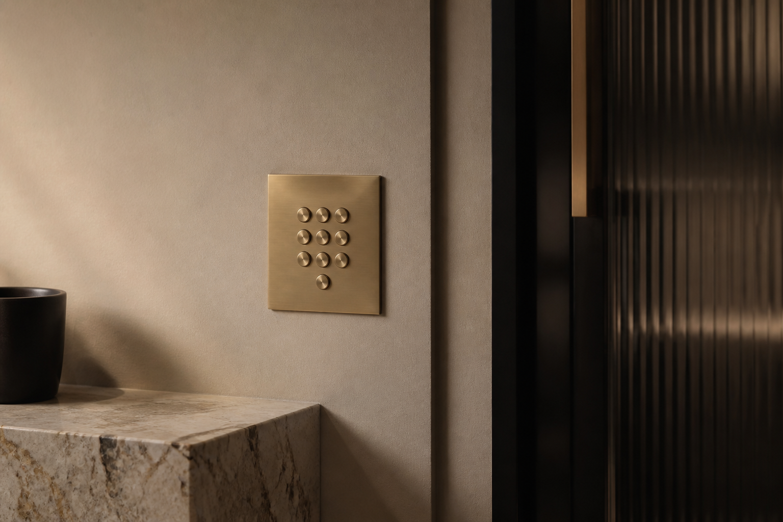 A precision-finished brass smart-home keypad in a luxury interior